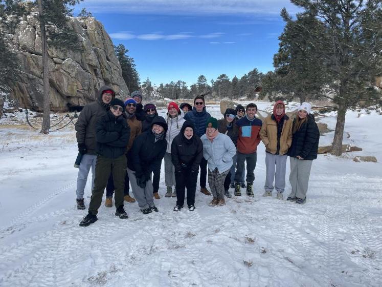 student group in snow with blue skies and mountains